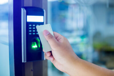 Door access control. Staff holding a key card to lock and unlock